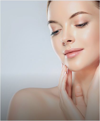 Woman with glowing, hydrated skin touching her jaw after IV therapy