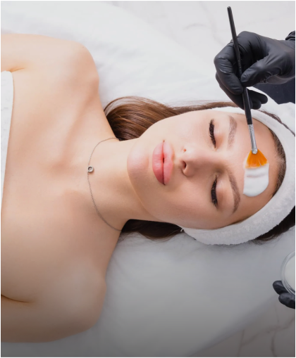 Provider applying a chemical peel to a client's face with a brush