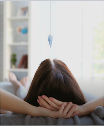Woman relaxing on a sofa at home with her hands behind her head