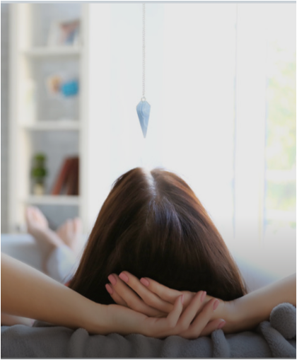Woman relaxing on a sofa at home with her hands behind her head