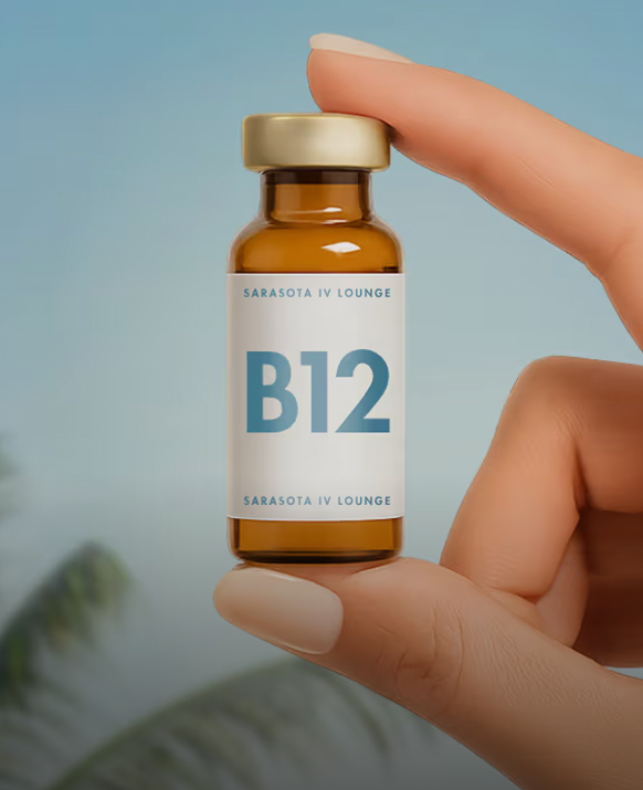 Hand holding a vial of vitamin B12 used in IV and injection therapy
