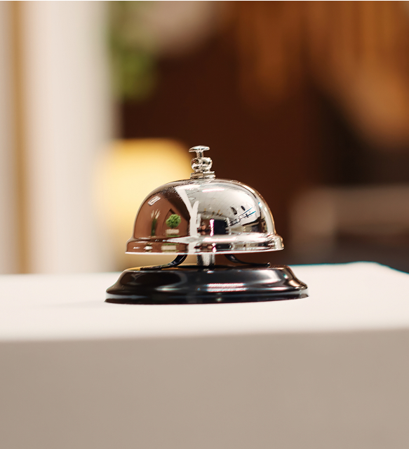 Silver concierge service bell on a table
