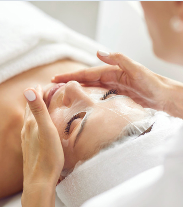 Client relaxing during a soothing facial massage treatment