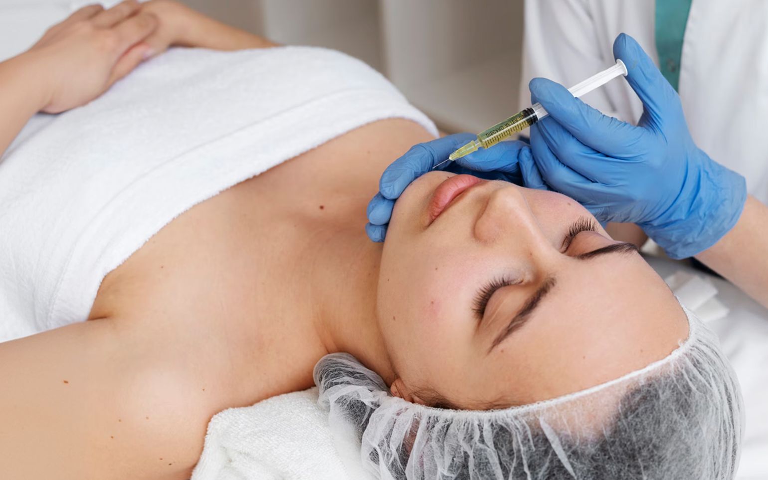 Provider giving a PRP facial injection to a client lying on a treatment bed